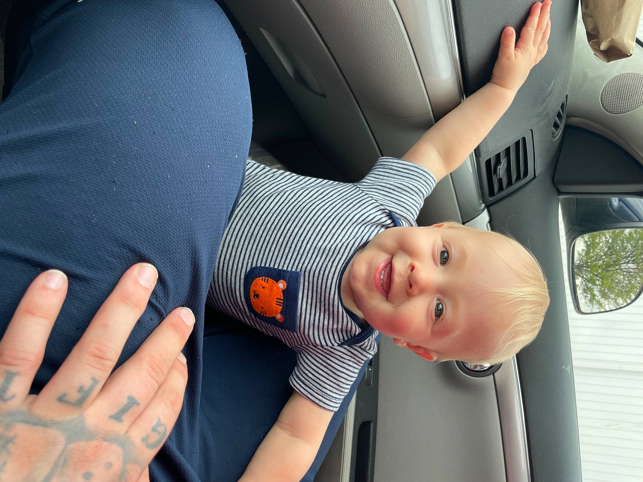 Liam joined the competition — help win amazing prizes! arm, auto_part, automotive_design, automotive_exterior, automotive_lighting, baby, car, car_seat, finger, gesture, hand, happy, joy, motor_vehicle, nail, person, smile, thumb, toddler, vehicle