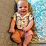 baby, smiling, infant, couch, pillow, clothing, suspenders, shorts, happy, face, skin, foot, hand, sitting, indoors, quilt, pattern, head, cute, portrait
