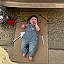 Jaxson joined the competition — help win amazing prizes! baby, child, overalls, cardboard, tools, wrenches, funnels, car, mustang_gt, headscarf, outdoor, concrete, garage, automotive, person, cute, smiling, feet, hands, playful