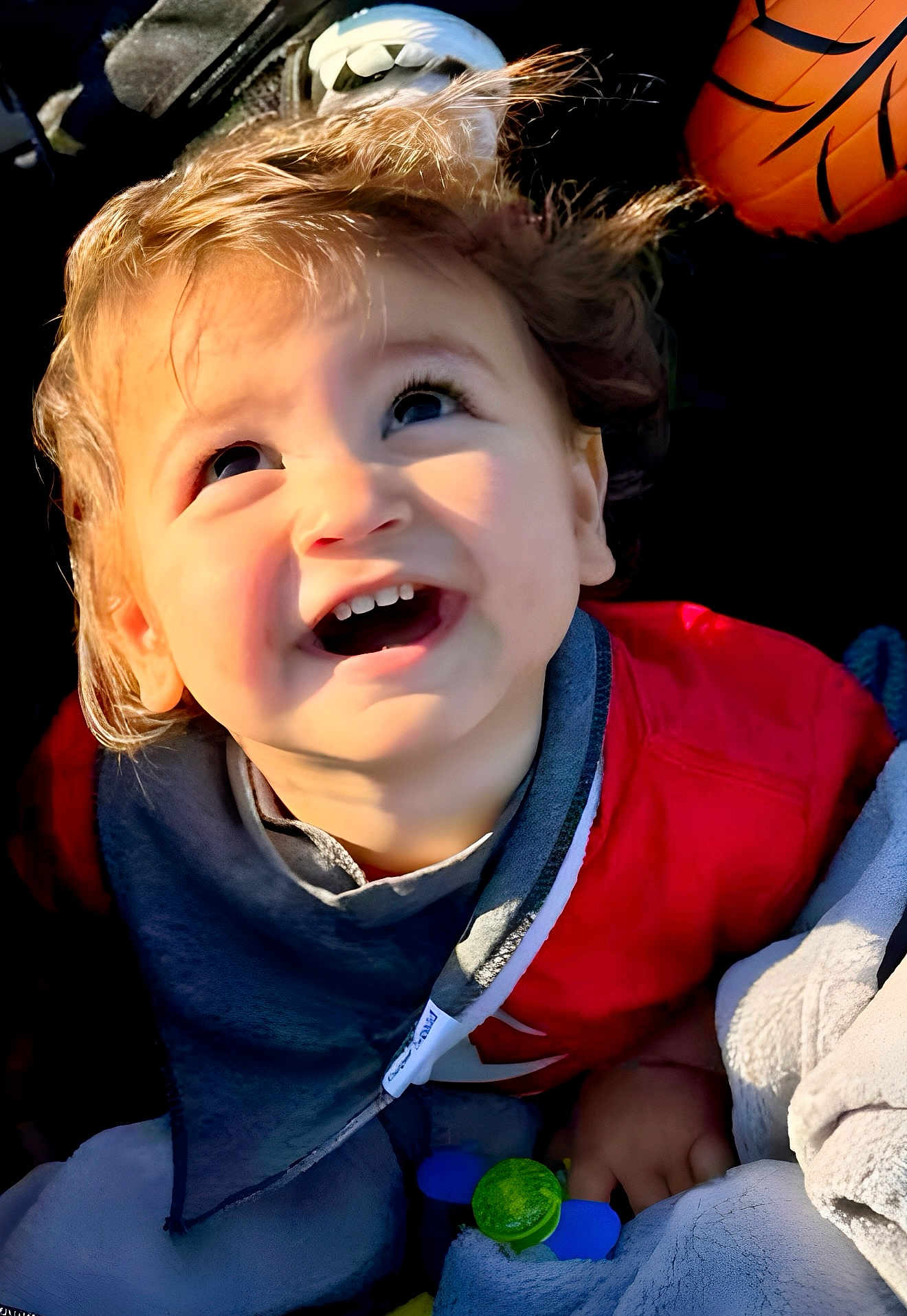 Isaiah joined the competition — help win amazing prizes! toddler, child, smiling, happy, face, hair, red_jacket, bib, blanket, toy, indoor, closeup, cute, baby, infant, portrait, warm_light, playing, joyful, expression