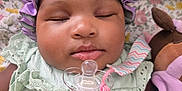 Nanyamka joined the competition — help win amazing prizes! baby, sleeping, pacifier, bonnet, purple, mint_green, clothing, soft_toy, blanket, floral_pattern, face, close_up, infant, cute, resting, indoors, child, peaceful, portrait, cozy
