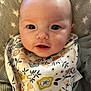 Raelon is registered to the contest to win money with this photo: baby, infant, face, eyes, bib, clothing, blanket, pattern, floral, cute, portrait, child, expression, skin, young, head, smile, laying, soft, indoors