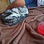 Pua is registered to the contest to win money with this photo: blanket, bottle, brown, cat, cozy, fur, indoor, leg, navy, person, pet, poster, red, relaxing, rest, shorts, sleeping, striped, tabby, wooden_wall