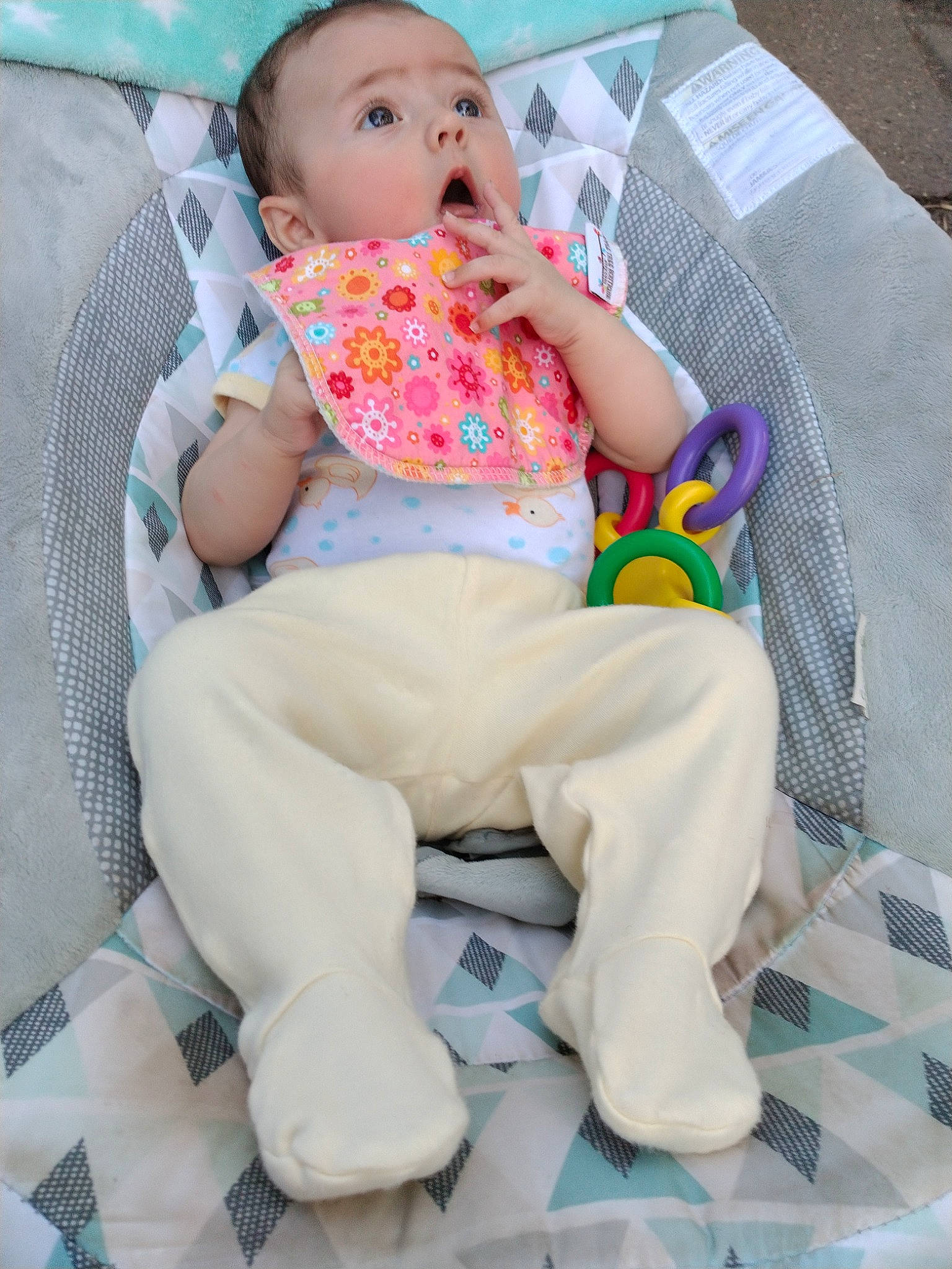 Pasiley is registered to the contest to win money with this photo: baby, baby_products, baby_toddler_clothing, chair, cheek, child, comfort, foot, green, knee, linens, pattern, person, sitting, skin, sleeve, sock, surprise, textile, thigh