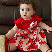 Danna is registered to the contest to win money with this photo: baby, child, curly_hair, cute, dress, fashion, floral_pattern, furniture, girl, hair_bow, indoors, leather_chair, photography, portrait, red_clothing, shoes, sitting, smiling, toddler, wide_eyes