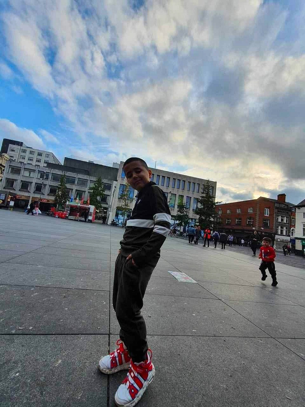 David is registered to the contest to win money with this photo: asphalt, building, cloud, footwear, human_leg, inline_skates, inline_skating, leisure, pedestrian, person, recreation, road, roller_skates, roller_skating, roller_sport, rolling, skating, sky, sports_equipment, travel