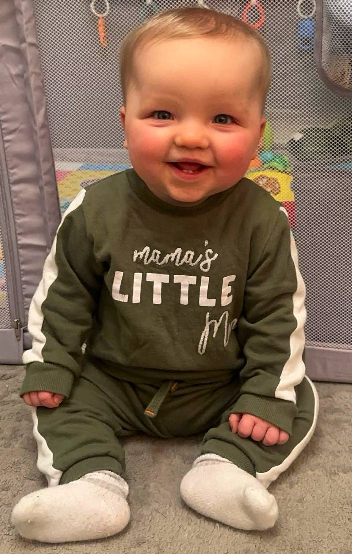 Milo joined the competition — help win amazing prizes! baby, baby_toddler_clothing, cheek, child, eye, face, floor, flooring, fun, hairstyle, happy, head, joy, long_sleeved_t_shirt, person, skin, sleeve, smile, sportswear, standing