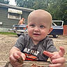 baby, child, outdoor, person, car, vintage_car, shirtless_person, house, wood, leaf, nature, greenery, playing, smiling, face, hands, short_sleeve_shirt, blue_eyes, daylight, curious