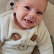 Marc participe au concours pour gagner de l'argent avec cette photo : baby, smiling, infant, child, cozy_clothing, bear_theme, plush, cushion, soft_texture, cute, happy, indoor, portrait, sitting, fuzzy, clothing, face, head, eyes, hand