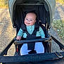 Mahlani joined the competition — help win amazing prizes! baby, stroller, child, smiling, outdoor, grass, pavement, clothing, person, cute, sunlight, seatbelt, jacket, happy, head, face, earrings, walkway, baby_clothes, leisure
