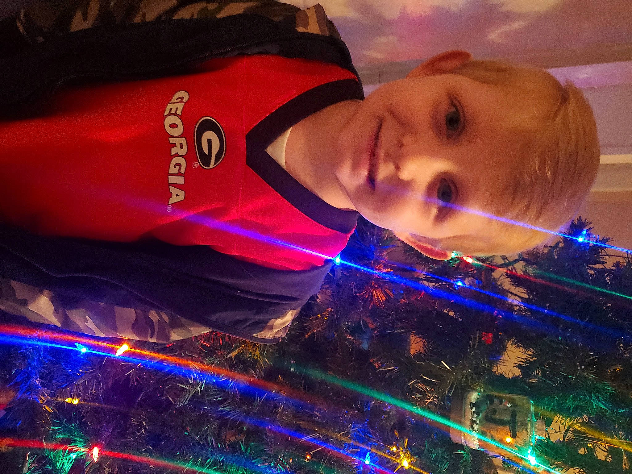 Easton is registered to the contest to win money with this photo: christmas, christmas_decoration, electric_blue, electricity, entertainment, event, flash_photography, fun, happy, holiday, joy, leisure, light, music, neon, person, purple, sky, smile, space