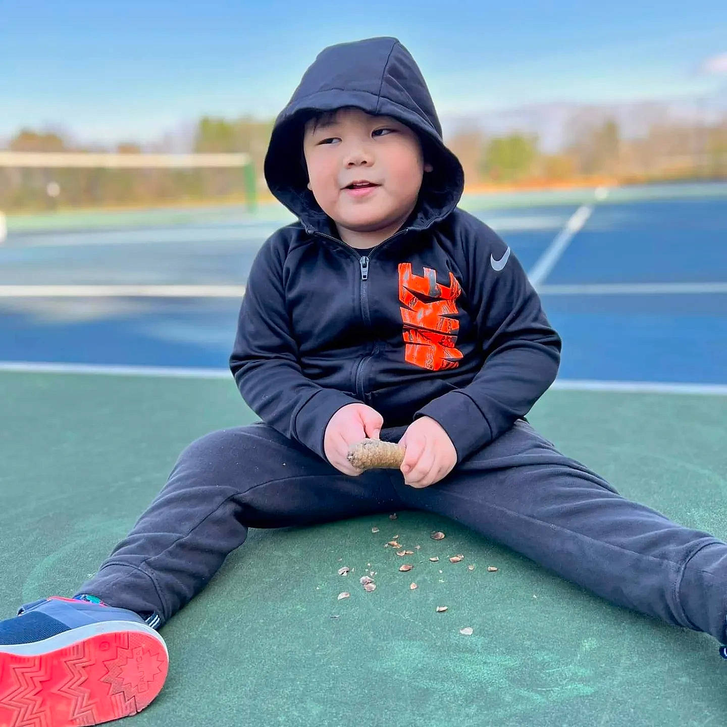 Dante joined the competition — help win amazing prizes! asphalt, cap, child, electric_blue, face, flooring, fun, grass, happy, headwear, jacket, leisure, person, plant, play, recreation, sitting, sky, sleeve, toddler