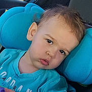 Kevin is registered to the contest to win money with this photo: toddler, child, face, closeup, car_seat, blue, cushion, curious, expression, young_child, indoors, clothing, person, portrait, head, hair, skin, eye, casual, seat