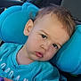 toddler, child, face, closeup, car_seat, blue, cushion, curious, expression, young_child, indoors, clothing, person, portrait, head, hair, skin, eye, casual, seat
