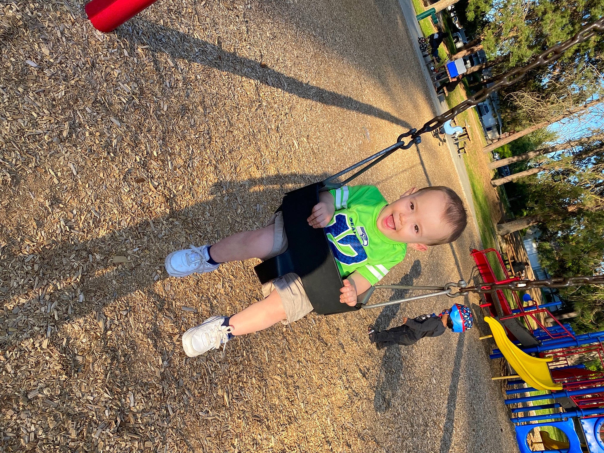 Greysen joined the competition — help win amazing prizes! asphalt, baby, child, city, fun, grass, landscape, leisure, outdoor_play_equipment, people_in_nature, person, play, playground, public_space, recreation, sand, shadow, soil, swing, toddler
