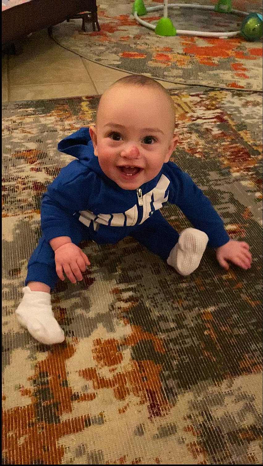 Brighton is registered to the contest to win money with this photo: baby, baby_toddler_clothing, clothing, eye, face, flash_photography, floor, flooring, grass, happy, hardwood, head, joy, outerwear, people_in_nature, person, skin, smile, t_shirt, toddler