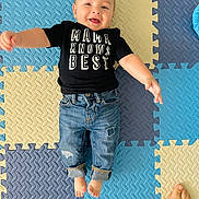 Mike is registered to the contest to win money with this photo: baby, bodypart, boy, child, clothing, cushion, face, head, homedecor, jeans, male, mat, pants, person, photography, portrait, quilt, shorts, sitting, t_shirt