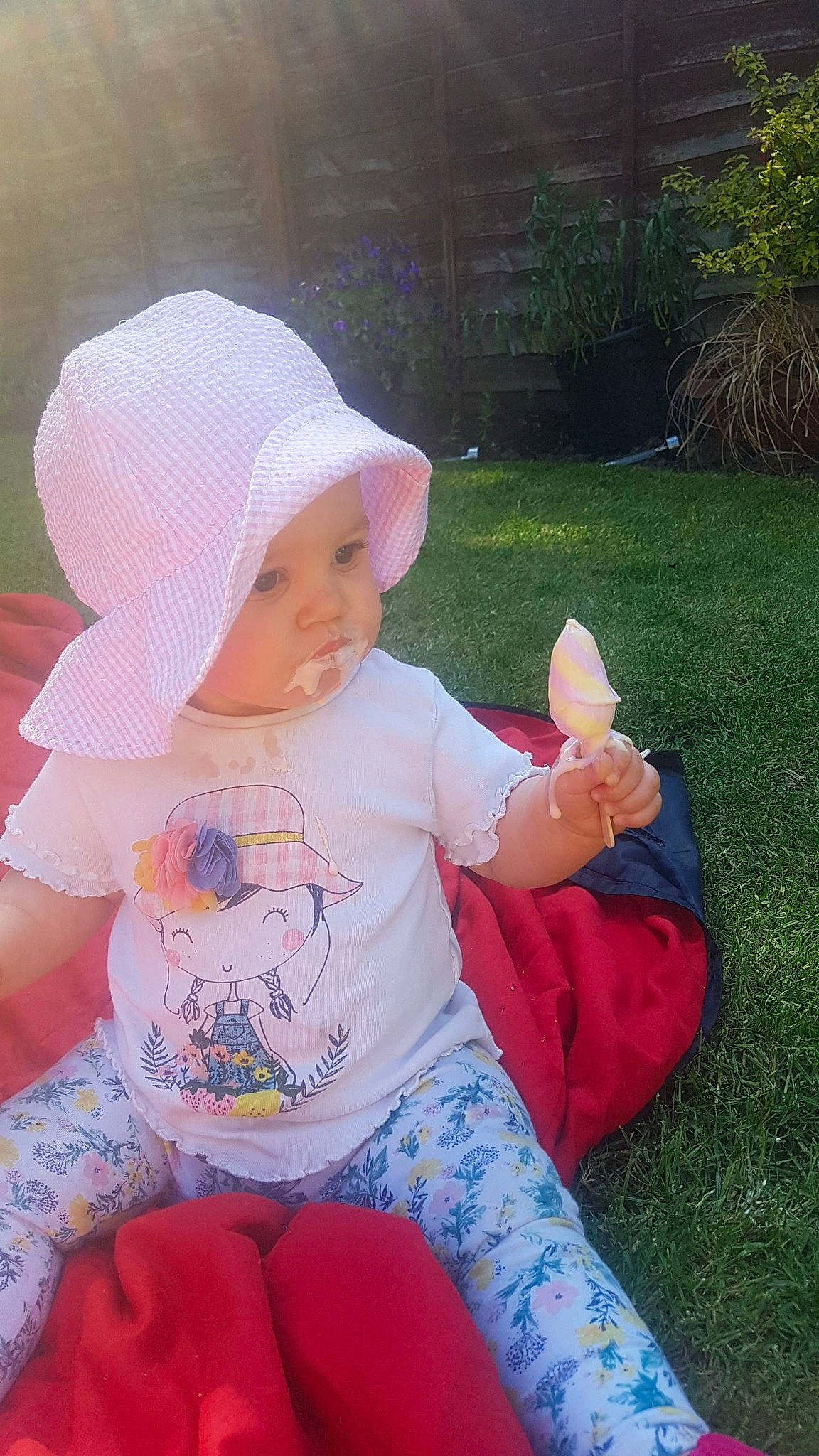 Bryony-mae is registered to the contest to win money with this photo: baby, child, finger, grass, headgear, headwear, person, pink, play, toddler