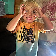 Johnny joined the competition — help win amazing prizes! child, blonde_hair, smiling, playful, tshirt, good_vibes, indoor, portrait, happy, cute, person, young, fun, light, hand_gesture, curly_hair, casual_clothing, cheerful, face, expression