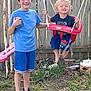 Jamey is registered to the contest to win money with this photo: backyard, barefoot, boy, child, curly_hair, fence, fun, grass, happy, outdoor, playground, shorts, sitting, smile, sneakers, standing, summer, swing, toy, tshirt