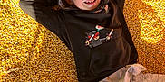 Jamey joined the competition — help win amazing prizes! casual, casual_clothing, child, childhood, corn_kernels, face, hand, happy, hoodie, leisure, outdoor, person, playful, portrait, relaxed, shadow, smiling, sunlight, yellow, young