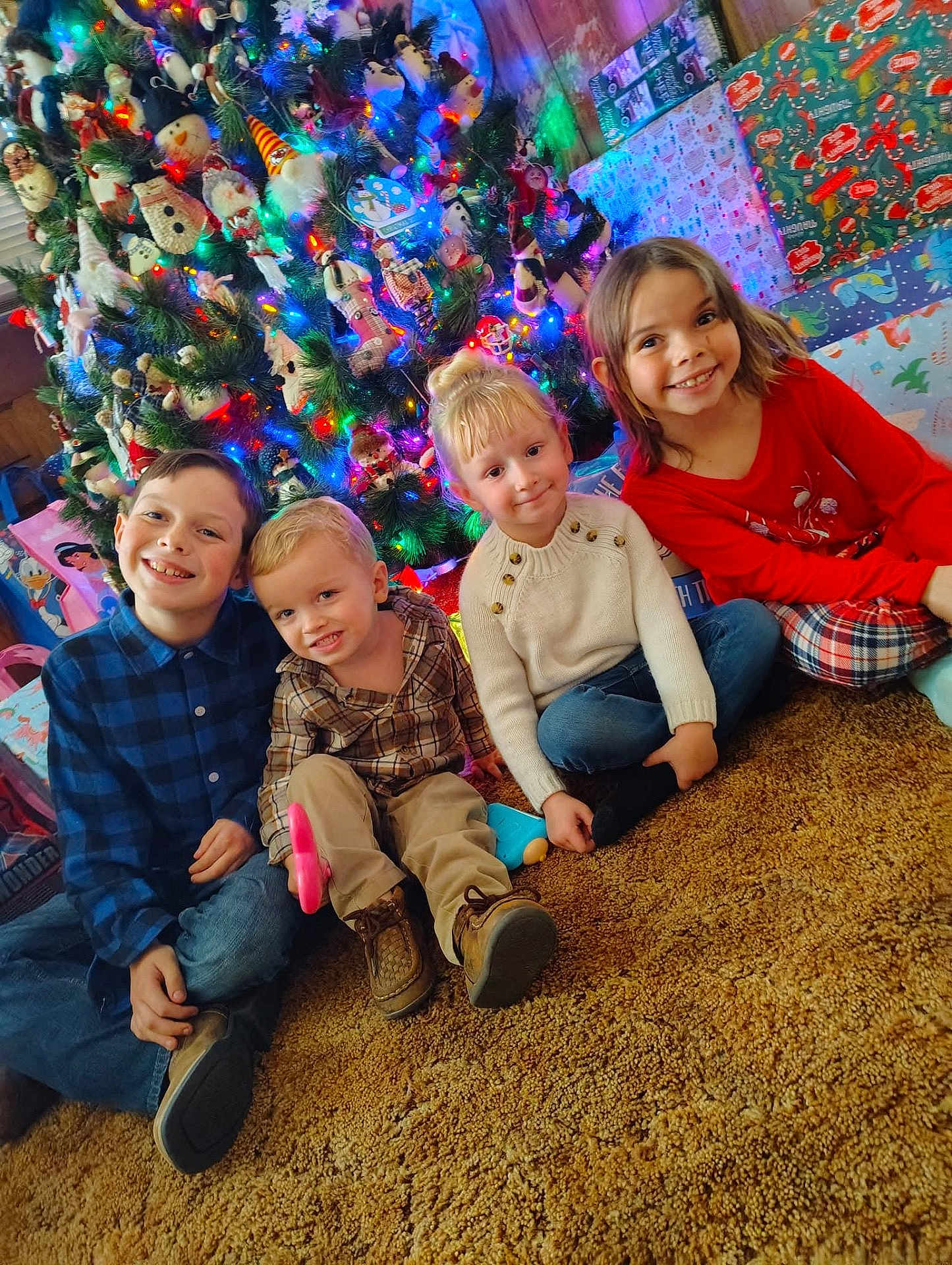 Jamey joined the competition — help win amazing prizes! carpet, casual_clothing, celebration, child, children, christmas_tree, colorful, decorations, family, festive, happy, holiday, home, indoor, portrait, presents, sitting, smiling, toddler, toys