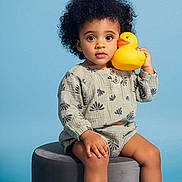 Camryn joined the competition — help win amazing prizes! toddler, child, curly_hair, rubber_duck, stool, blue_background, casual_clothing, sneakers, sitting, portrait, cute, indoor, playful, young_child, person, studio, toy, expression, feet, fashion