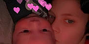 Aaron is registered to the contest to win money with this photo: child, baby, face, love, hearts, filter, kiss, closeup, portrait, indoor, red_shirt, striped_blanket, affection, family, cuddle, young, people, skin, expression, cozy