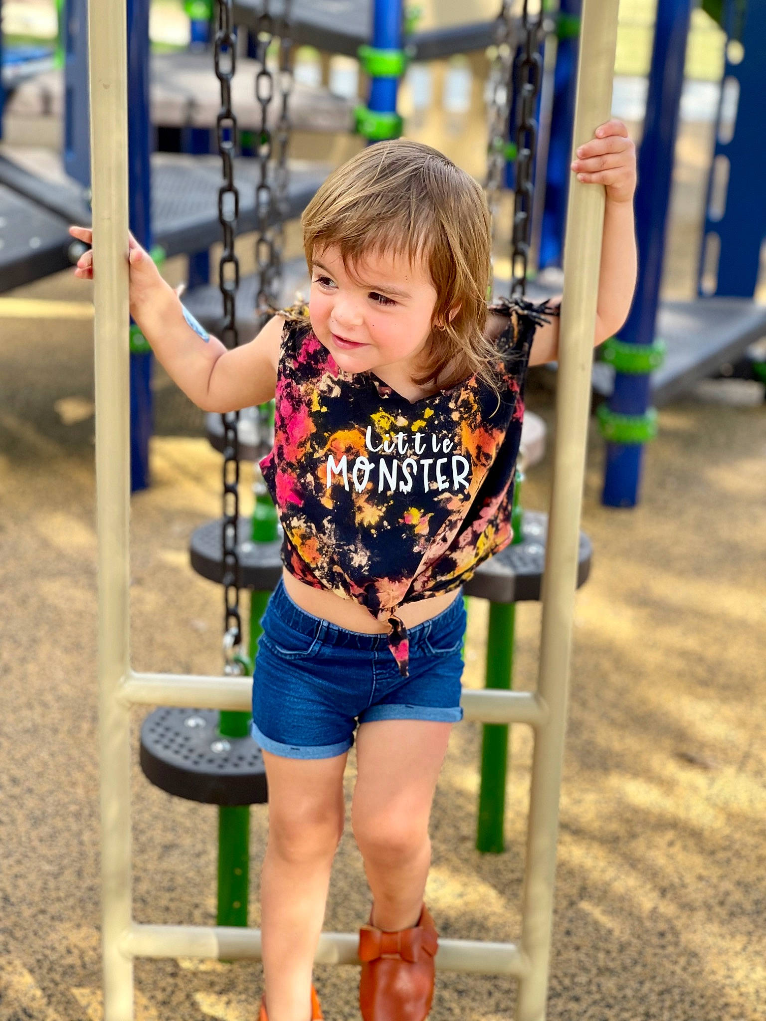 Mallory joined the competition — help win amazing prizes! child, city, electric_blue, fun, happy, human_leg, leisure, outdoor_play_equipment, person, playground, recreation, sleeve, smile, soil, street_fashion, summer, swing, t_shirt, thigh, toddler