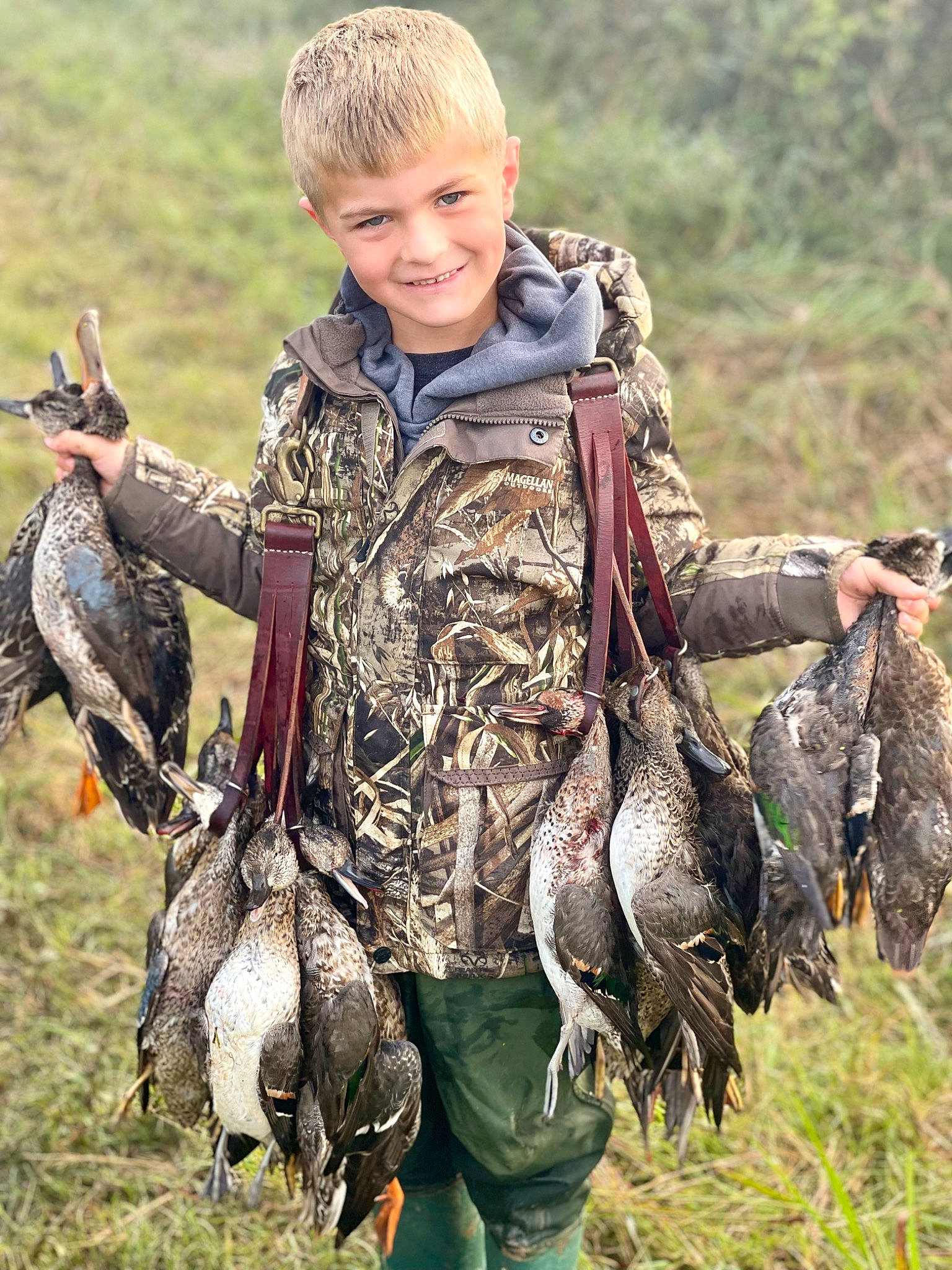 Lawson is registered to the contest to win money with this photo: adaptation, beak, bird, camouflage, eye, face, galliformes, grass, grassland, hunting, joy, military_camouflage, military_uniform, person, phasianidae, plant, recreation, smile, terrestrial_animal, water_bird