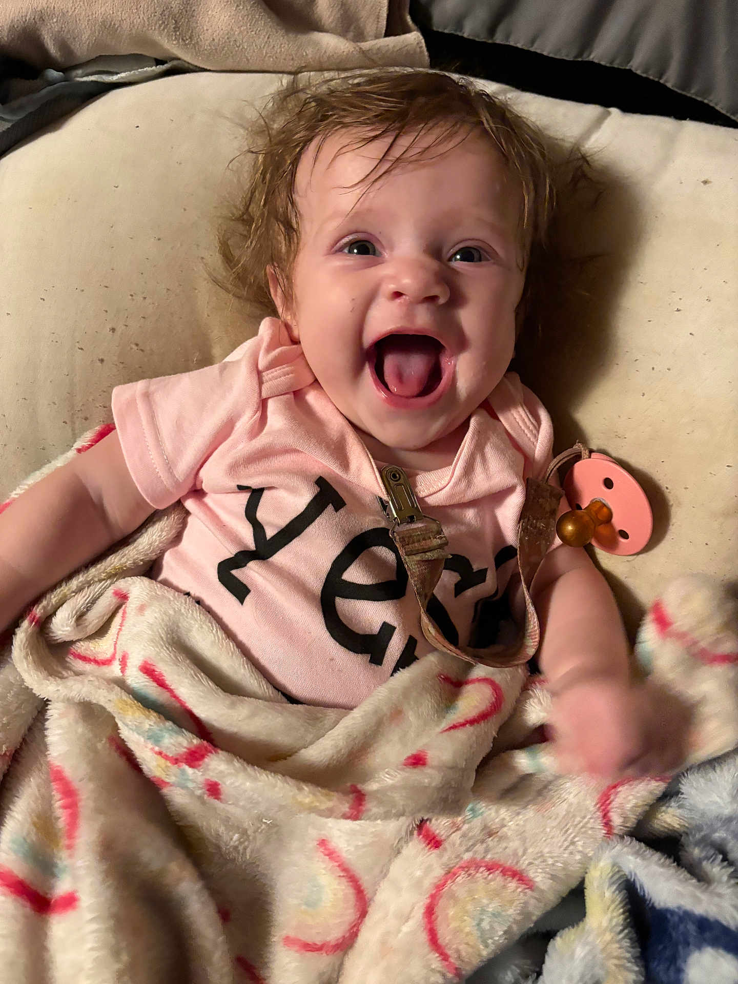 Paradise is registered to the contest to win money with this photo: animal, baby, babylaughing, blanket, bodypart, canine, clothing, couch, dog, face, finger, furniture, hand, happy, head, person, pet, photography, portrait, t_shirt