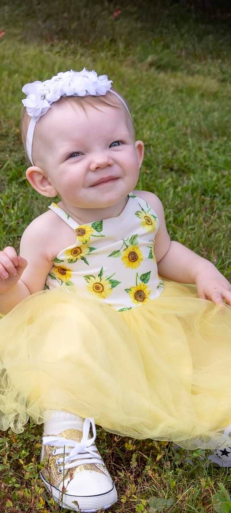Ashlyn is registered to the contest to win money with this photo: baby, baby_toddler_clothing, beauty, cheek, child, dress, face, fun, grass, happy, iris, joy, pattern, people_in_nature, person, photograph, pink, plant, sitting, skin