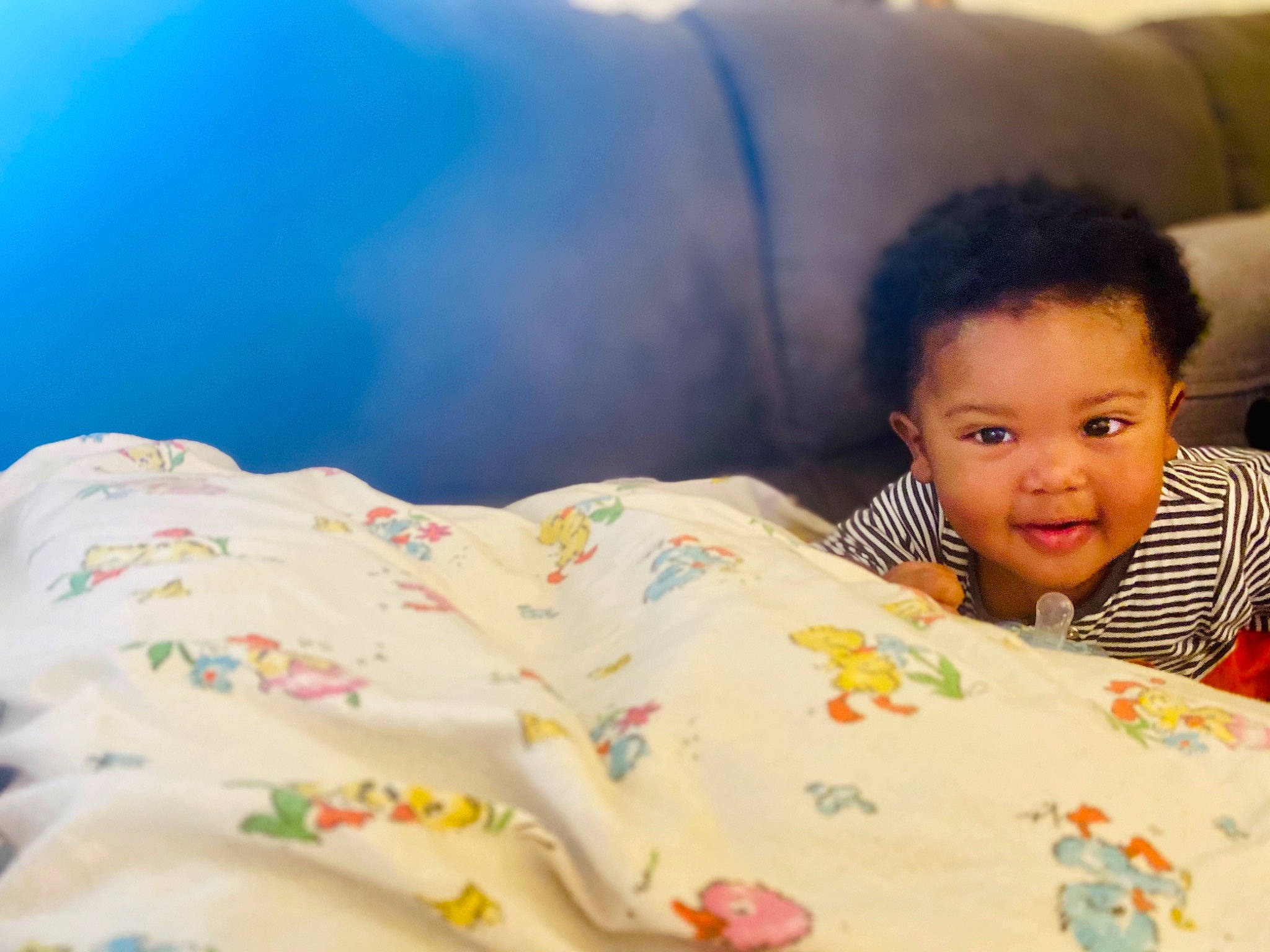 Coby is registered to the contest to win money with this photo: child, comfort, eye, eyebrow, facial_expression, grass, hair, hairstyle, happy, head, human_body, leisure, linens, lip, neck, nose, person, skin, smile, t_shirt