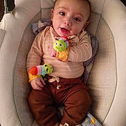 Isaiyel Gurule is registered to the contest to win money with this photo: baby, infant, child, baby_seat, wrist_rattles, blanket, brown_pants, striped_shirt, cozy, cute, smiling, indoors, floor, soft_lighting, playful, caterpillar_toy, happy, young_child, comfortable, portrait