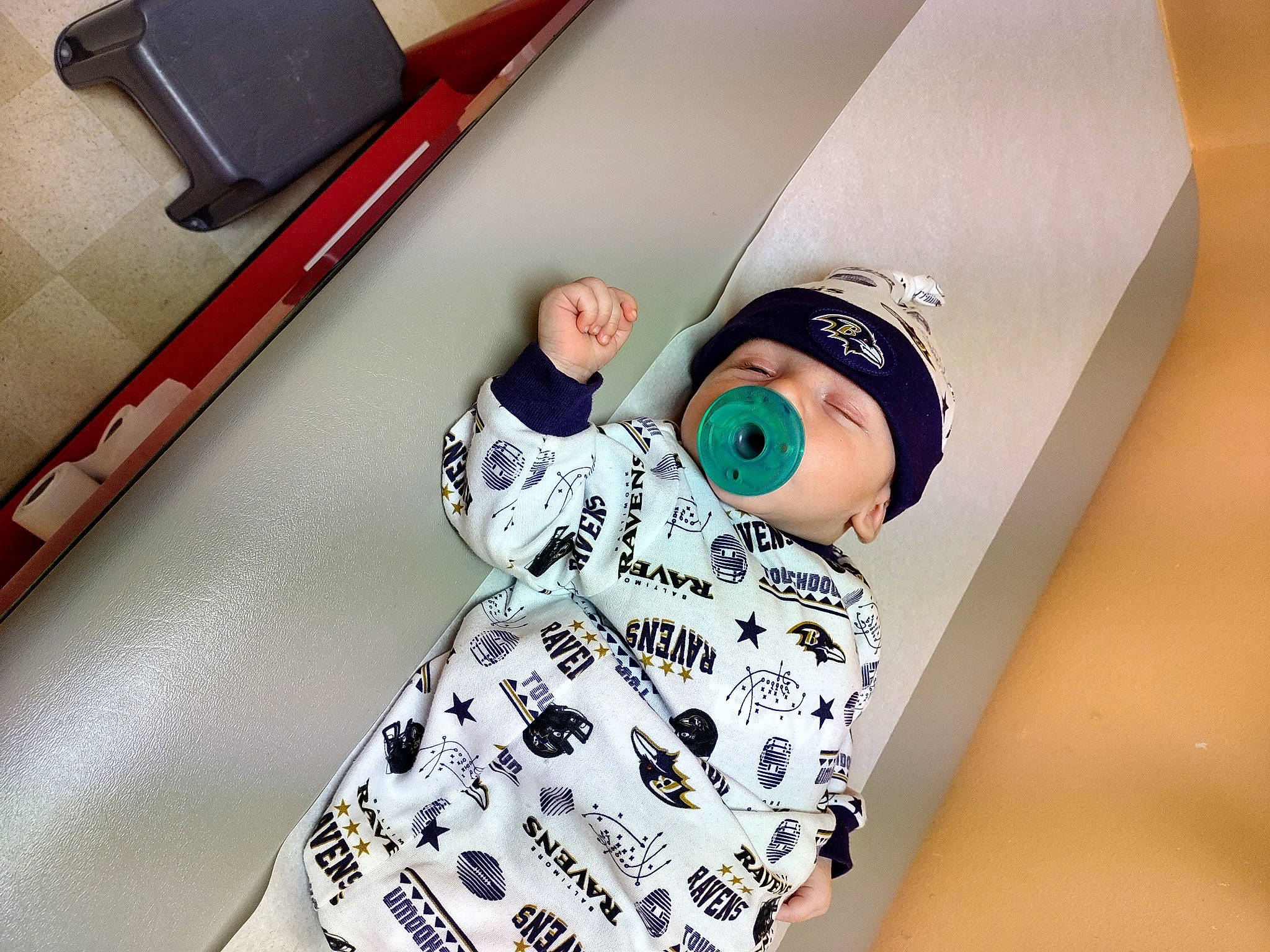 Zach is registered to the contest to win money with this photo: baby, baby_toddler_clothing, bag, cap, child, eyewear, fashion_accessory, fashion_design, font, hat, headwear, linens, metal, pattern, person, room, sitting, sleeve, t_shirt, toddler