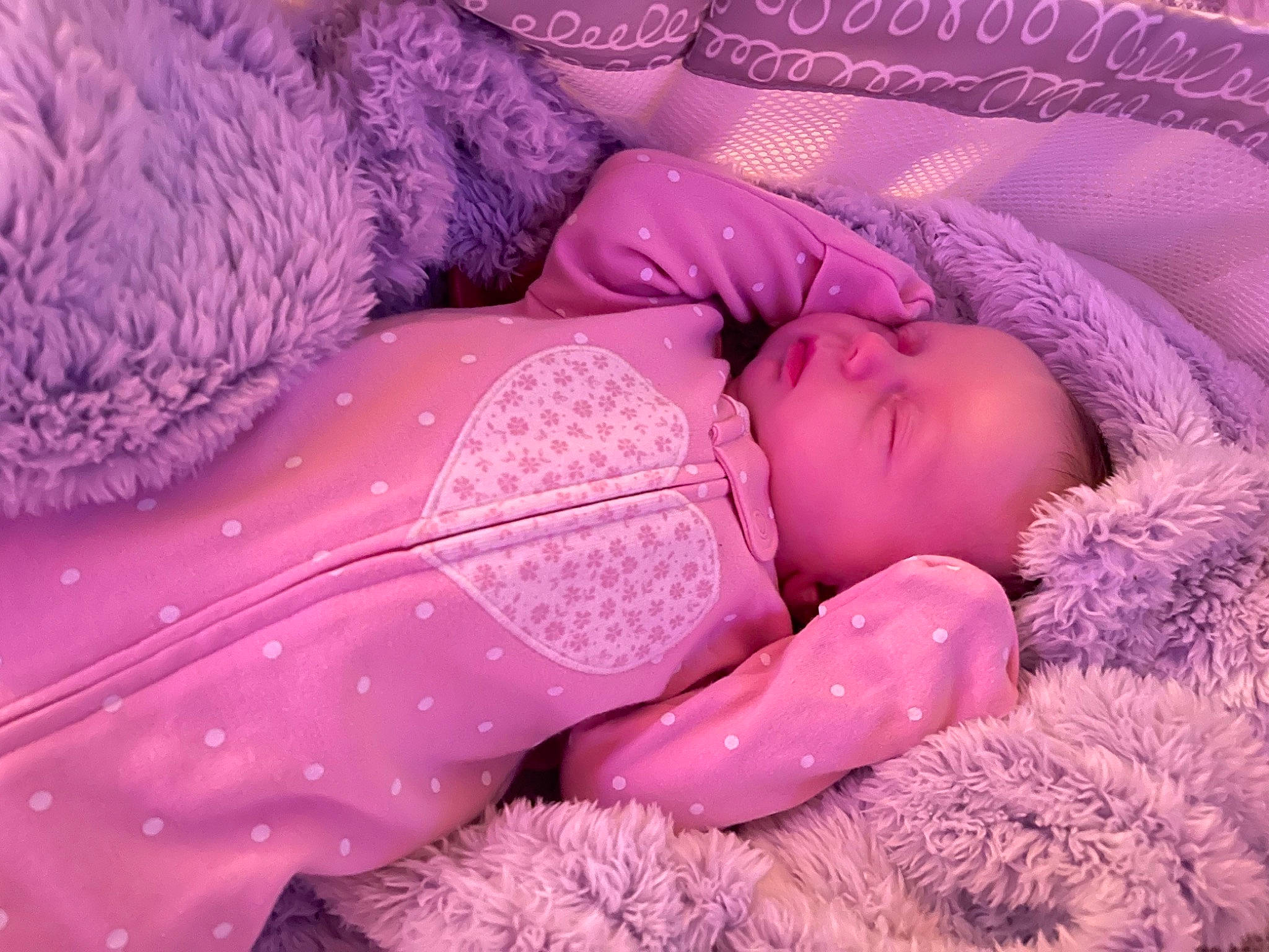 Lyrica is registered to the contest to win money with this photo: baby, baby_sleeping, baby_toddler_clothing, bed, bed_sheet, bedding, bedtime, child, comfort, hand, head, linens, magenta, pattern, person, pink, purple, skin, toddler, toy