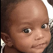 Gabryel participe au concours pour gagner de l'argent avec cette photo : baby, child, face, eyes, smile, striped_clothing, person, portrait, head, skin, hair, expression, indoor, holding, adult, curious, close_up, young_child, candid, casual