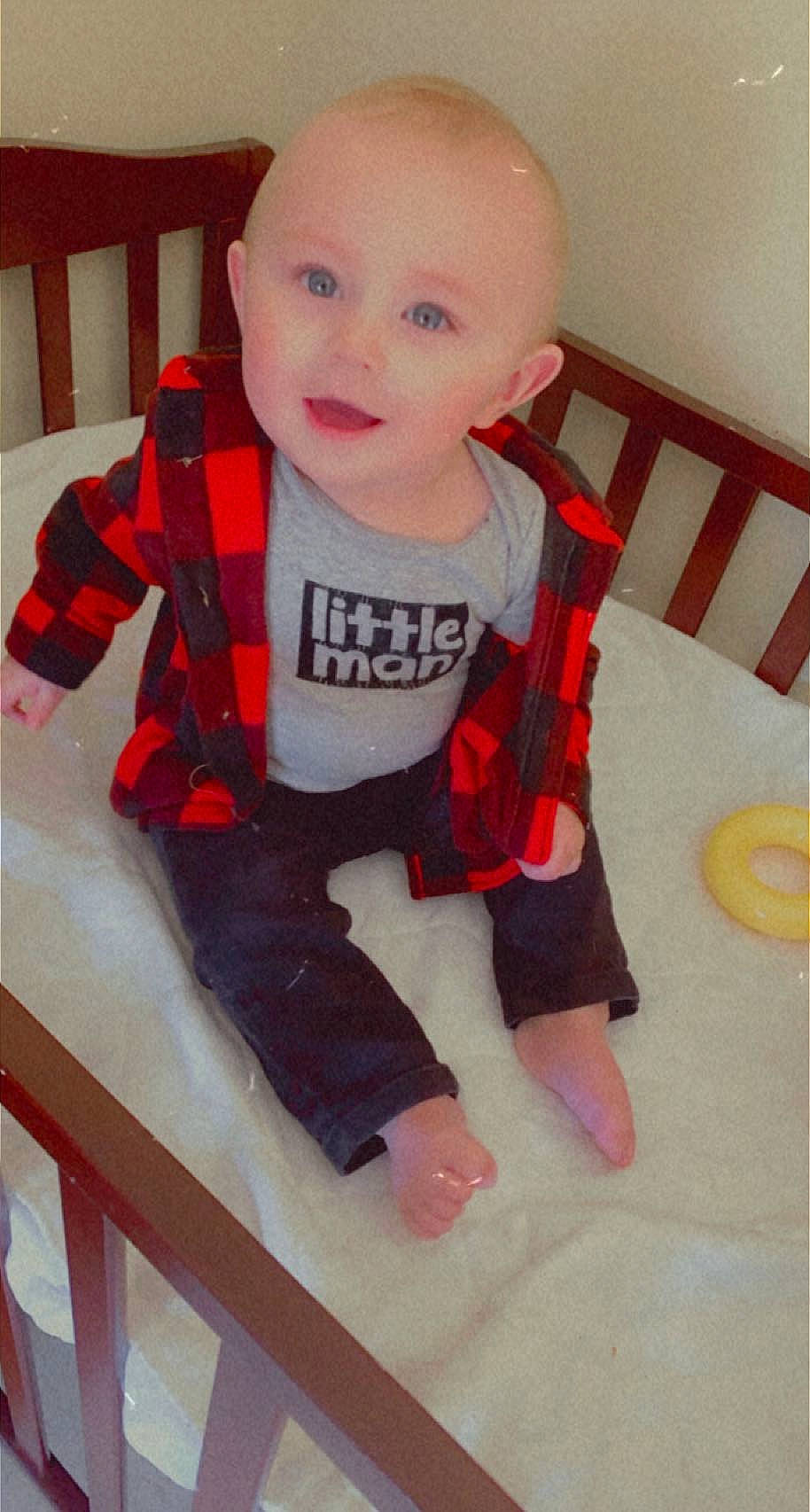 Drake is registered to the contest to win money with this photo: arm, baby, baby_products, baby_toddler_clothing, cheek, child, comfort, face, fun, head, knee, leg, pattern, person, skin, sleeve, smile, standing, t_shirt, thigh