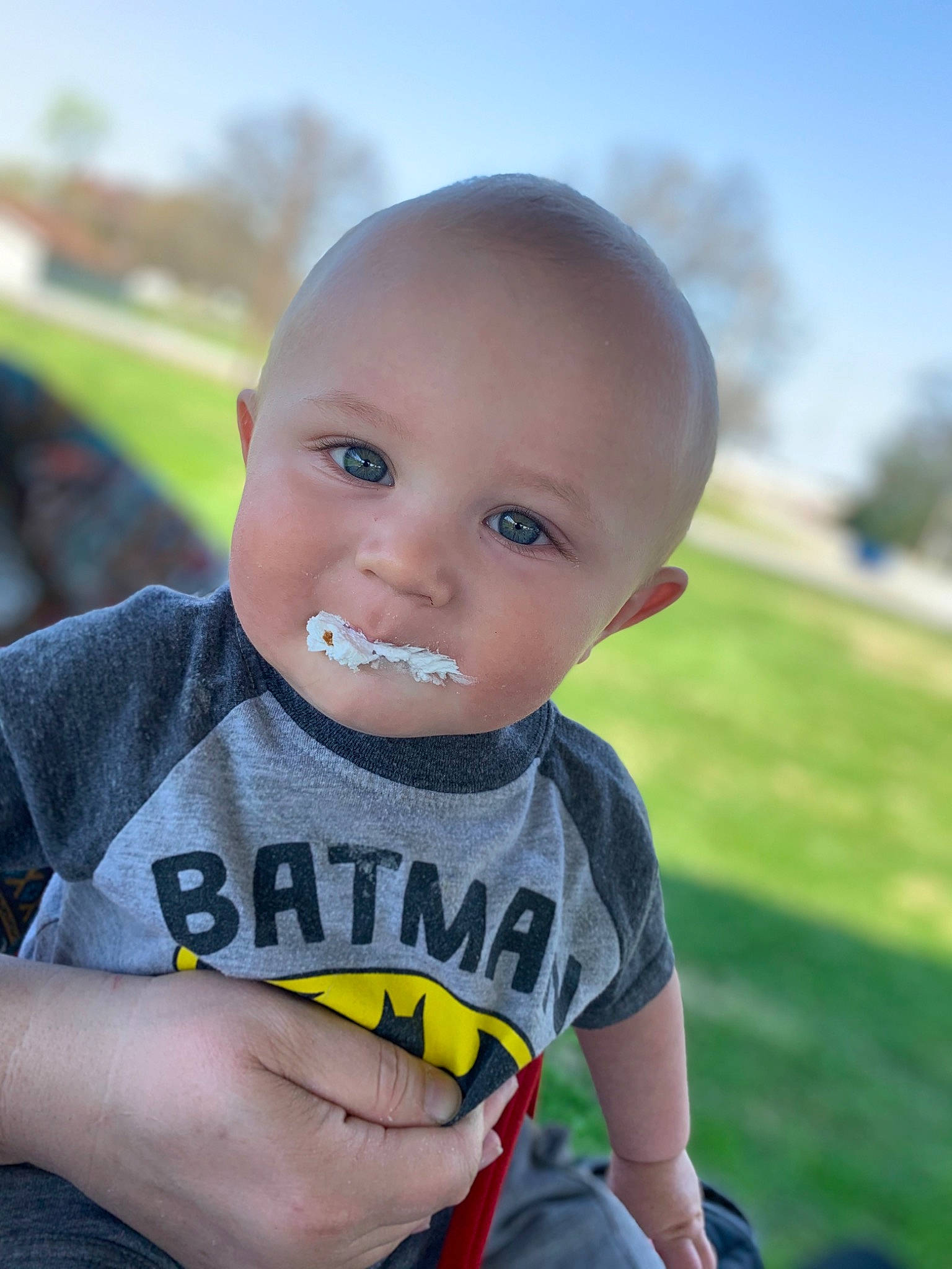 Drake is registered to the contest to win money with this photo: baby, baby_toddler_clothing, child, cool, eye, finger, fun, grass, happy, people_in_nature, person, plant, sitting, skin, sky, sleeve, smile, t_shirt, thumb, toddler