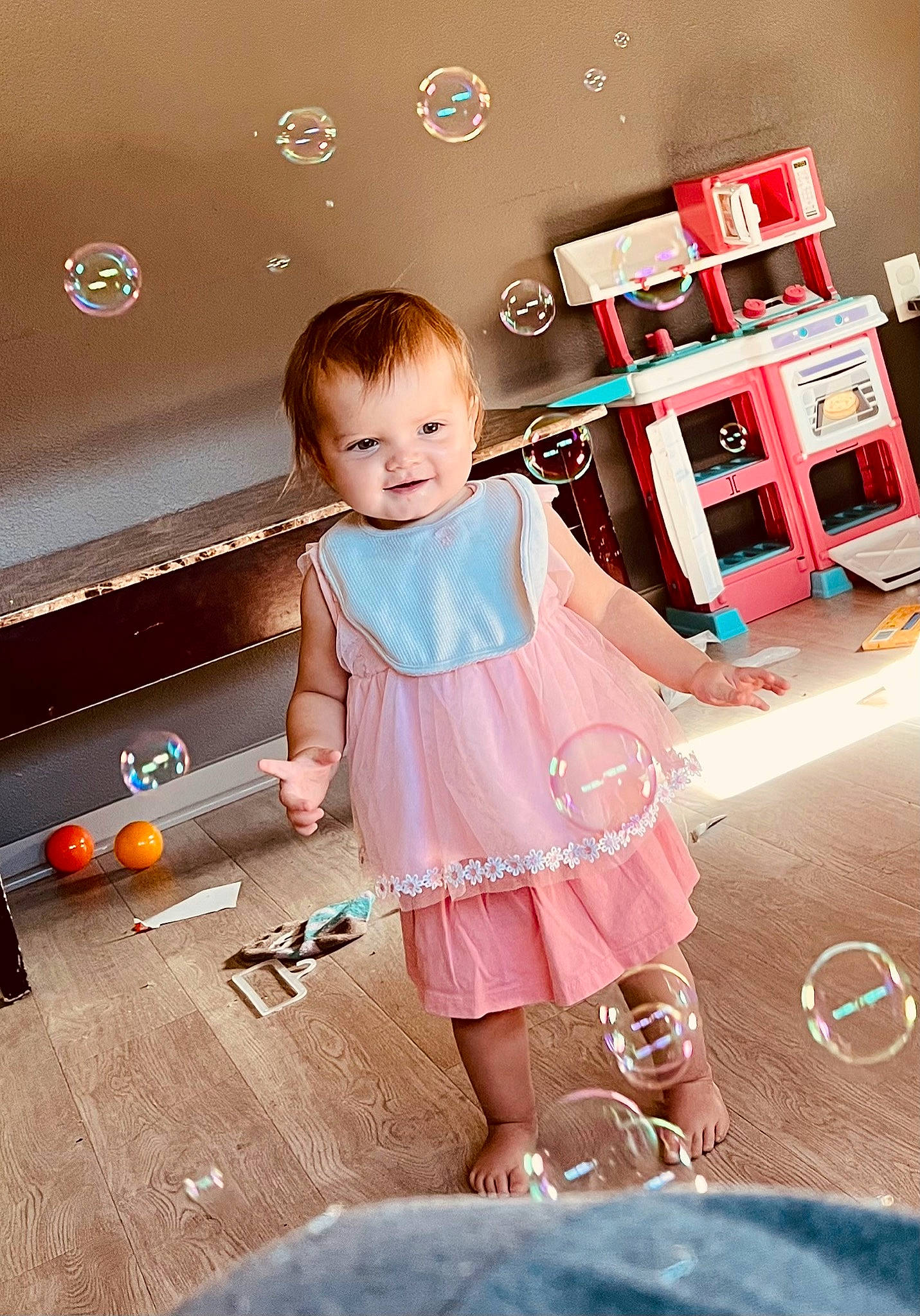 Raven is registered to the contest to win money with this photo: baby, baby_toddler_clothing, child, day_dress, dress, fashion_design, flash_photography, flooring, fun, happy, joy, magenta, one_piece_garment, orange, person, pink, product, skin, sleeve, toddler