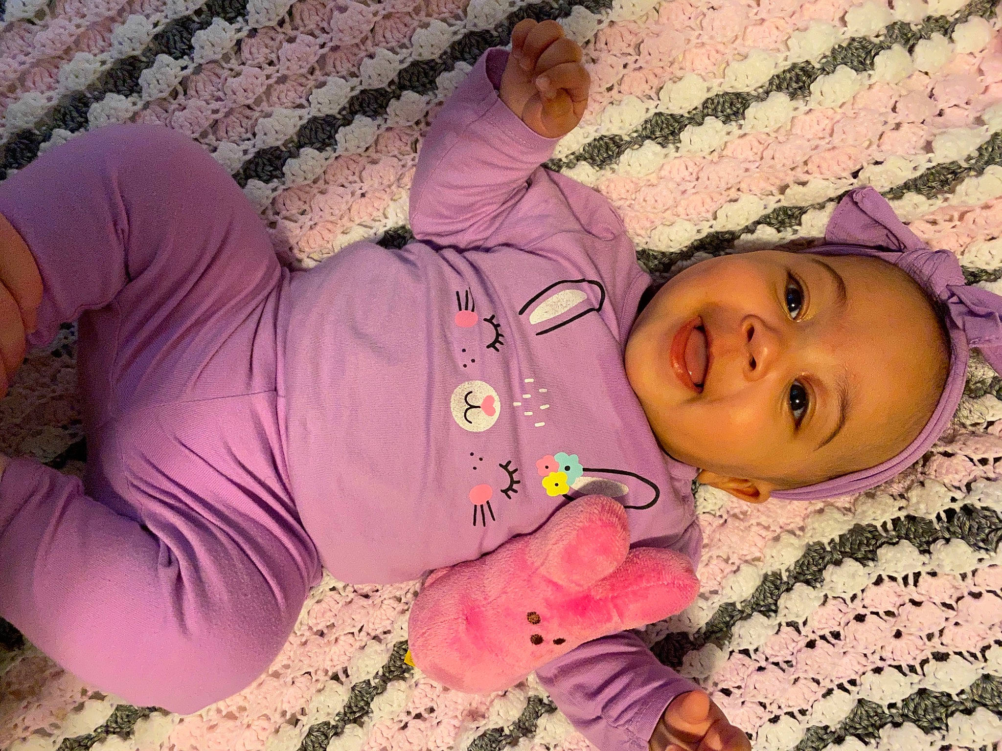 Avalynn is registered to the contest to win money with this photo: baby, baby_toddler_clothing, cheek, child, clothing, finger, fun, grass, hand, happy, magenta, mouth, nose, people_in_nature, person, pink, plant, purple, smile, thigh