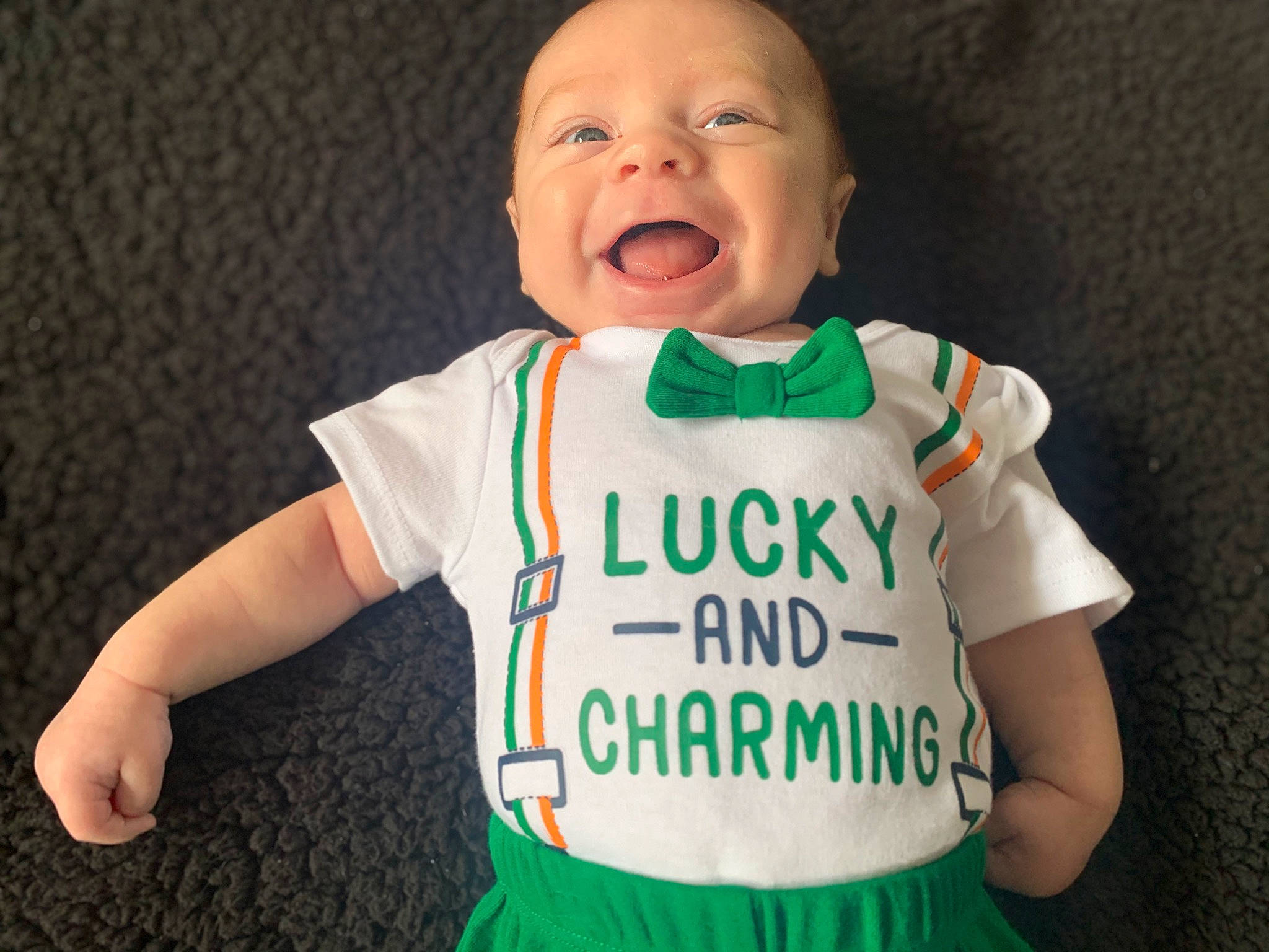 Carsyn is registered to the contest to win money with this photo: arm, baby, baby_toddler_clothing, cheek, eye, face, finger, gesture, hair, happy, head, human_body, jersey, joint, neck, outerwear, person, shoulder, skin, sleeve