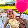 Makiyah joined the competition — help win amazing prizes! baby, infant, basket, pink_bow, balloon, outdoor, sunlight, greenery, blanket, headband, smile, happy, wooden_chair, field, summer, cute, child, portrait, pink, yellow_outfit