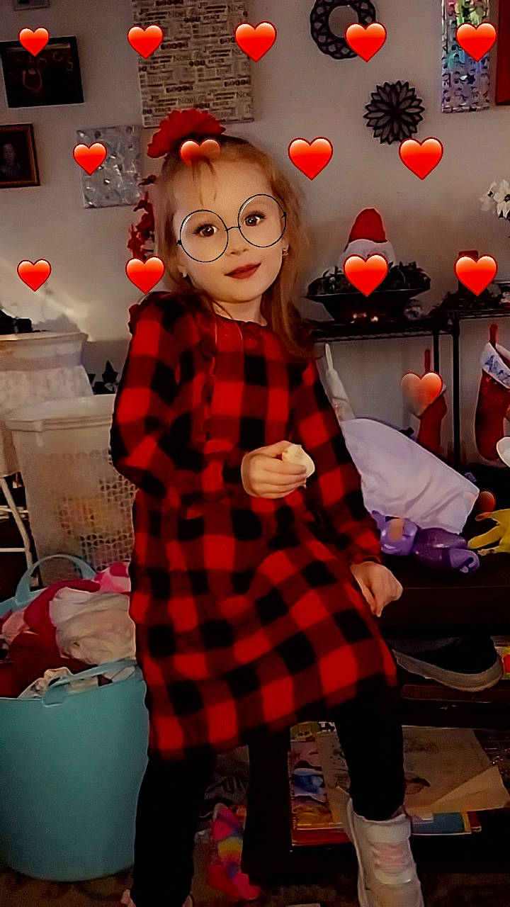 Brittany is registered to the contest to win money with this photo: bag, carmine, child, costume, event, eyewear, fashion_design, fun, fur, happy, holiday, luggage_and_bags, pattern, person, plaid, red, room, sleeve, tartan, textile