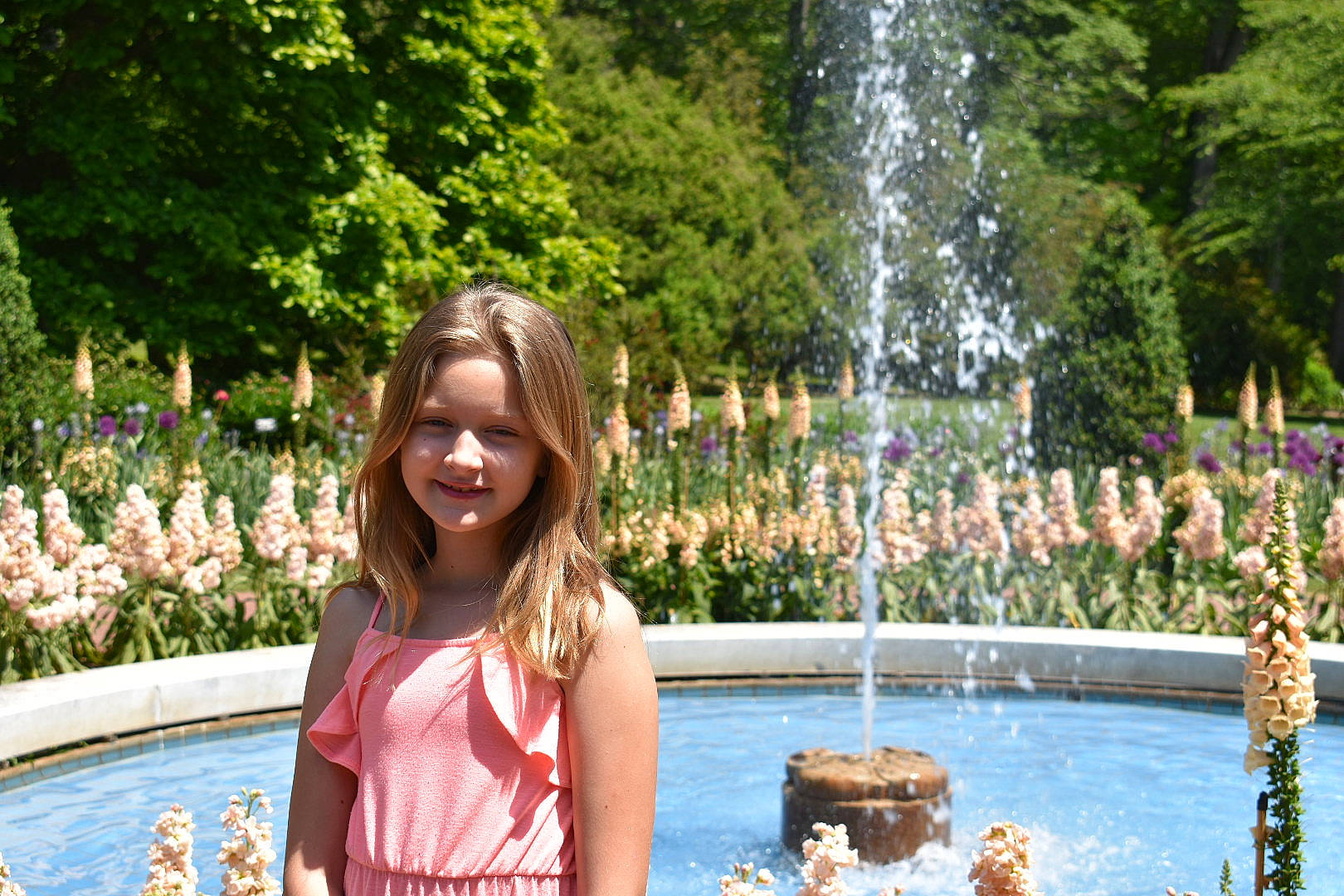 Sara joined the competition — help win amazing prizes! body_of_water, botany, flower, fountain, fun, grass, happy, joy, leisure, nature, people, people_in_nature, person, plant, recreation, shrub, smile, summer, travel, tree