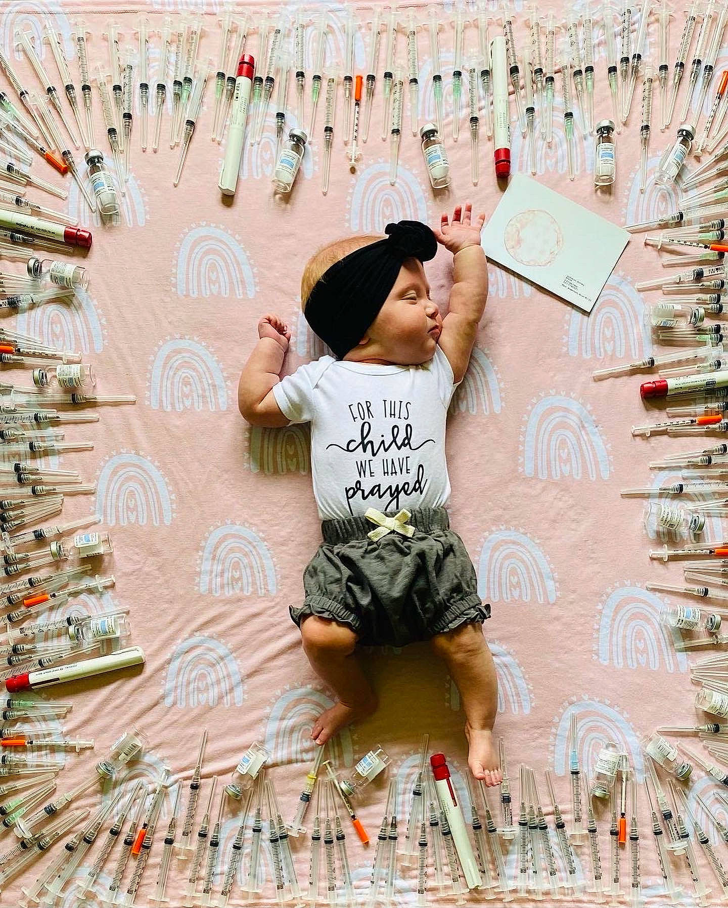 Jayla is registered to the contest to win money with this photo: cap, child, event, facial_expression, font, fun, graphic_design, happy, hat, headwear, holiday, leisure, pattern, person, shorts, sitting, t_shirt, textile, thigh, toddler