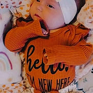 Hayden Joanne is registered to the contest to win money with this photo: baby, infant, headband, bow, sweater, floral_pants, blanket, polka_dot, cute, child, newborn, lying_down, hand_near_face, soft_lighting, indoors, cozy, clothing, portrait, face, sleepy