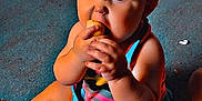 Kahleesi Lynn joined the competition — help win amazing prizes! baby, child, carpet, floor, snack, eating, sitting, indoor, blue_eyes, colorful_clothing, toy, household, diaper, hand, foot, skin, hair, person, cute, infant