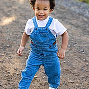 Maserati joined the competition — help win amazing prizes! toddler, child, denim_overalls, white_shirt, white_sneakers, curly_hair, smiling, outdoor, gravel_path, sunlight, happy, walking, nature, greenery, casual_clothing, cute, portrait, daylight, person, fashion