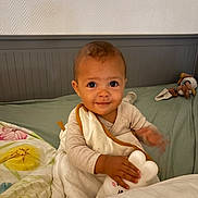 Wesley participe au concours pour gagner de l'argent avec cette photo : baby, bed, blanket, child, comfort, cozy, cute, expression, face, furniture, hand, head, indoors, infant, person, plush_toy, sleepwear, smile, toddler, young_child